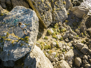 aerial view of young man in casual hiking the mountain on a summer day
