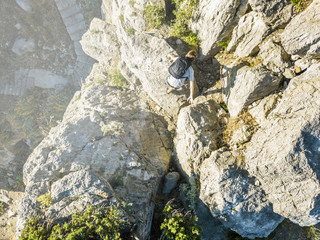 aerial view of young man in casual hiking the mountain on a summer day