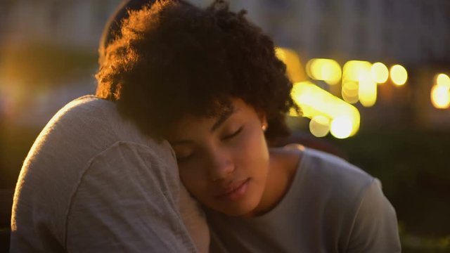 Cute afro-american woman cuddling with boyfriend, trusting relationship together