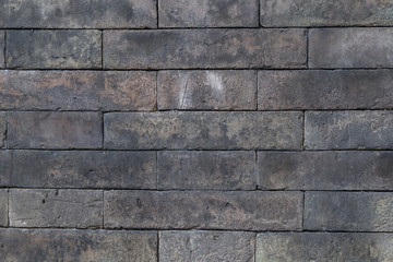 Background of aged grey color brick wall texture