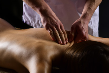 Obraz na płótnie Canvas spa massage. spa salon services. man make massage for woman in spa. spa therapy for naked girl. stress removing.