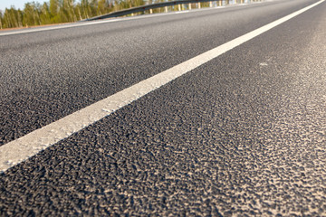 Road marking line on asphalt close-up