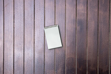 Empty of small pocket book on wooden table, copy space, for presnetation