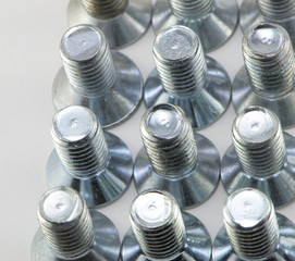 Machine-building screws closeup on white background