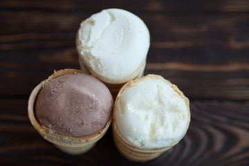 Vanilla ice cream in waffle cup isolated on wooden background. Summer concept.