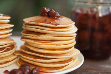 Pancakes with strawberry jam for a breakfast.