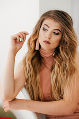 Naklejka premium Portrait of beautiful young woman with makeup in fashion clothes