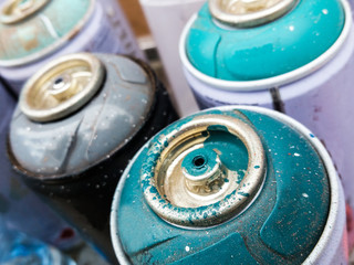 Used cans of spray paint to make urban art on wall.