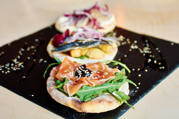 cold seafood appetizers on a plate with soy sauce