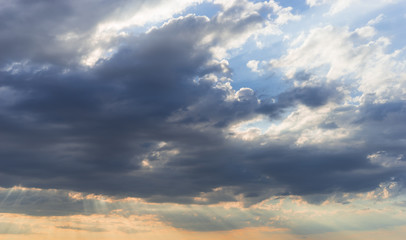Sky with clouds and sunlight at sunset. colorful and cheerful, wallpaper or texture
