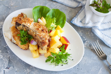 Crusted cod with peach and pineapple salsa