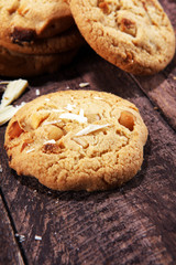 stack of macadamia nut and white chocolate cookies on table with chocolate chip