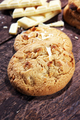 stack of macadamia nut and white chocolate cookies on table with chocolate chip