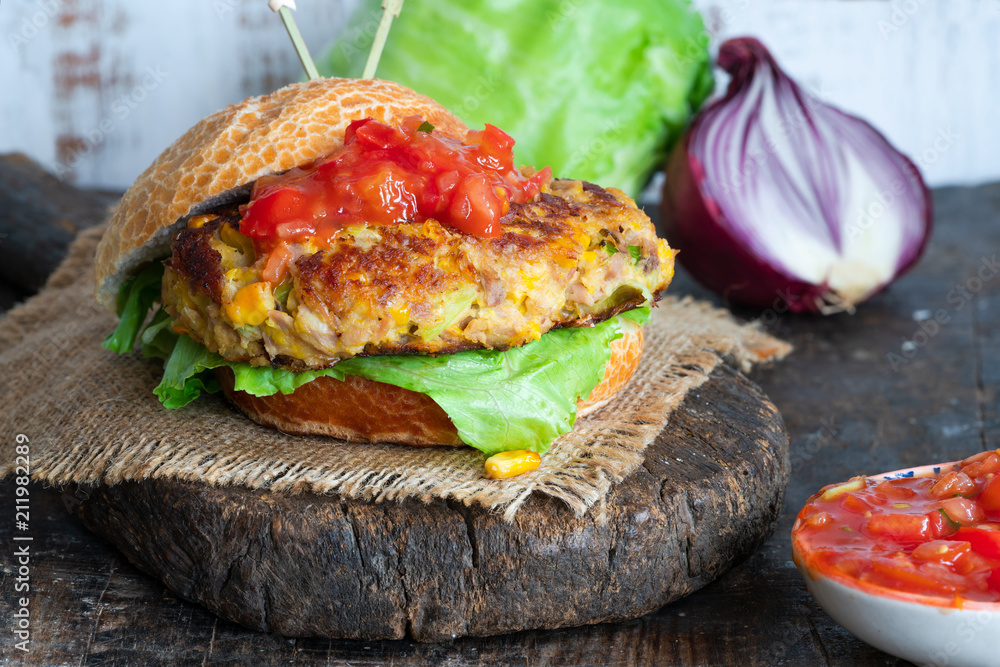 Wall mural tuna and sweetcorn burger with tomato salsa in a bun