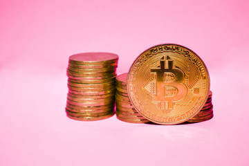 Gold bitcoin on a pink background. Crypto currency.