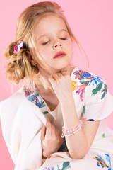 Portrait of a beautiful girl on a pink background.