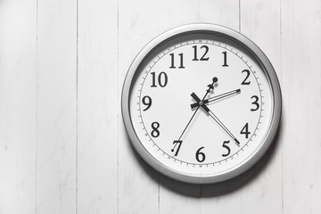 Clock on color wooden plank wall