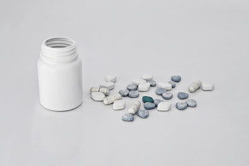 Medicines, supplements and drugs in a bottle on white background