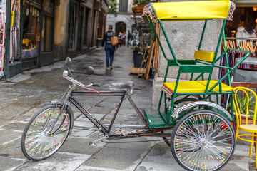 Delivery bike located in a typical street next to the Plaza Mayor in Madrid