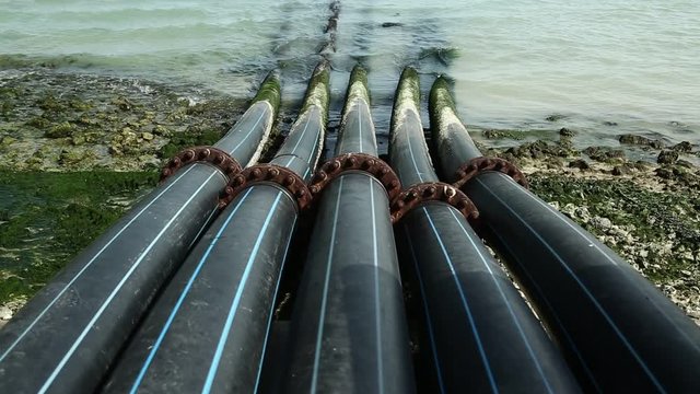 Pipes for intake of sea water and desalination in Doha, Qatar. Desalinization of sea water for city needs, water intake from Persian Gulf, Arabian Peninsula