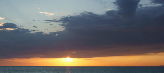 Orange sunset over sea horizon