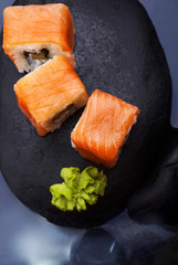 Close up of sushi maki California set .Sushi. On dark stone with fog ..Creative shot. Japanese...