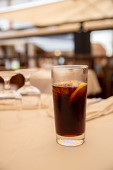 Glass of cold drink in street cafe.