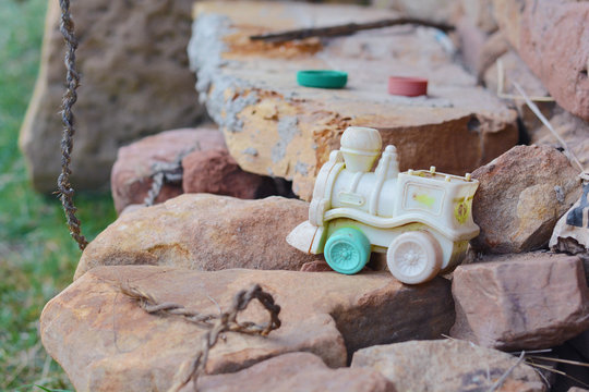 Abandoned old toy train left outside.