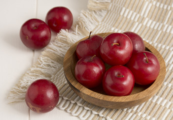 Fresh red plums, on white background.
