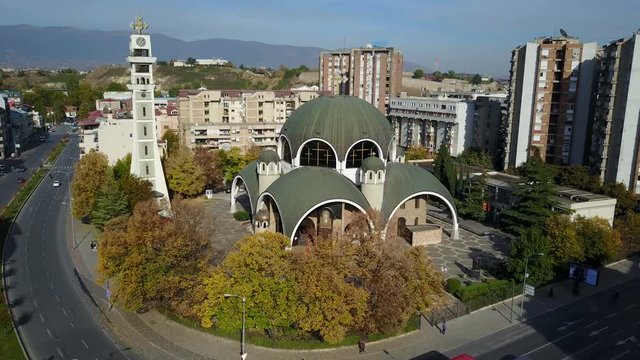 Aerial shot of clock tower and domes of unusual Saint Clement of Ohrid Orthodox church in Skopje, Macedonia