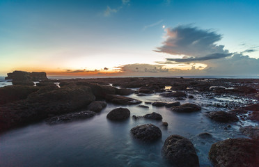Fototapeta na wymiar Small rocks in the shore of the Indian Ocean in Bali, Indonesia.