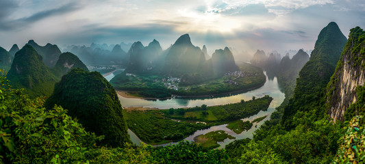 Beautiful Li river sunrise with sun rays, little towns and farmland