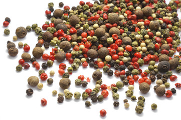 Black, red and white pepper grains isolated on white. Spice. Food.