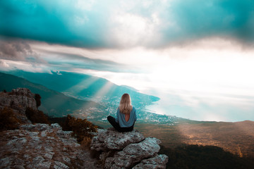 Girl walking on the mountain top over blue sea Crimea view