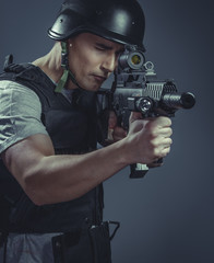 recreation player wearing protective helmet aiming pistol ,black armor and machine gun