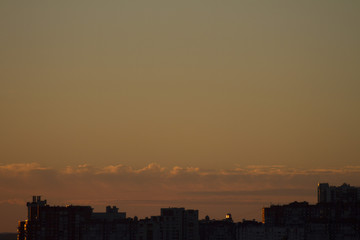 Sunset over the city. Twilight and high-rise buildings landscape. Bright sunset over the horizon