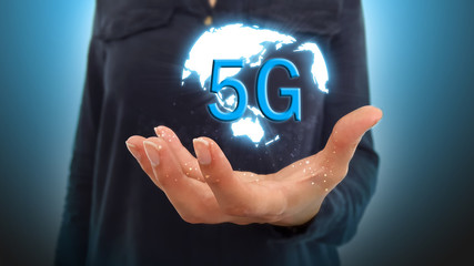 Businesswoman on blurred background using 5G network interface