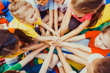 Group of children putting their hands together - 211993246