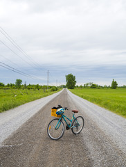 Fototapeta premium Old recreational bike in the middle of a gravel road