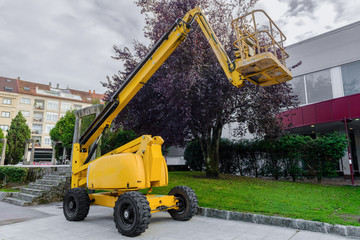 yellow aerial platform on the street