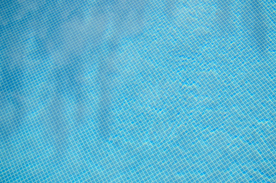 Blue water in vibrant swimming pool, rippled light serene turquoise idyllic background