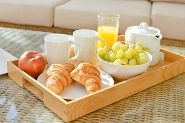 Plate with tasty croissants on table, closeup relaxing background
