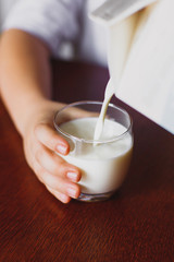 Milk is poured into a mug.