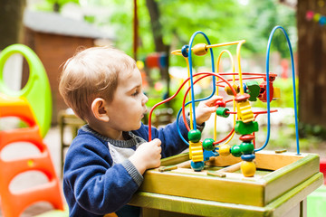 Little kid boy plays
