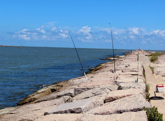 Fishing Poles in the Jetties Next to Ocean