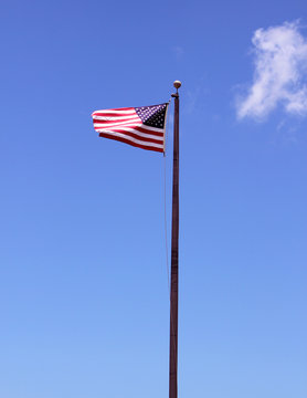 American Flag Waving Low Angle with Blue Skys