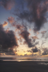 Sunrise over the beach horizon with beautiful clouds and color in the sky 