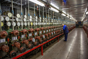 The engineer adjusts the measuring equipment in the workshop of the production plant
