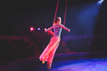 Performance of the girl aerial acrobat in the circus.