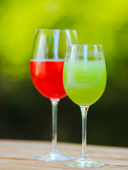 Summer cocktail. Fruit cocktail on green background. Citrus fruits, berries, strawberries, blueberries, mint, ice.